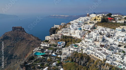 Aerial drone photo of iconic picturesque village of Imerovigli built on top of steep hill with amazing views to Caldera and Santorini island, Cyclades, Greece