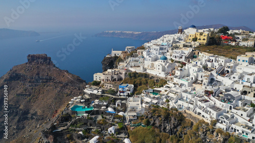 Aerial drone photo of iconic picturesque village of Imerovigli built on top of steep hill with amazing views to Caldera and Santorini island, Cyclades, Greece