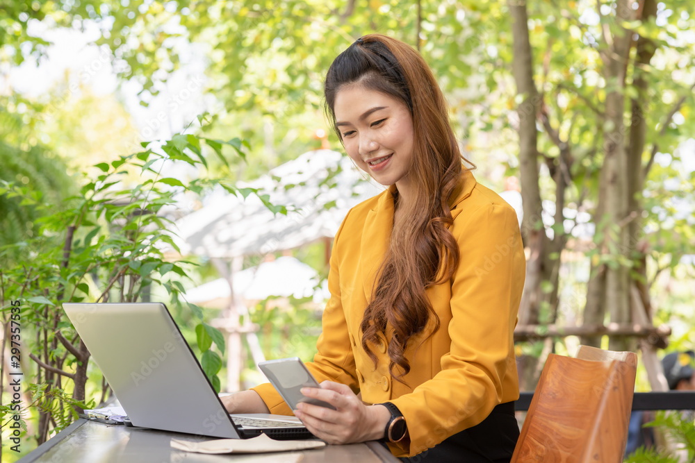 Beautiful Young Asian Woman smile and using Smartphone to connecting social media or Shopping online from App in device at coffee shop cafe enjoy and happiness,Woman with Smartphone Concept Beautiful Young Asian Woman smile and using Smartphone to connecting social media or Shopping online from App in device at coffee shop cafe enjoy and happiness,Woman with Smartphone Concept