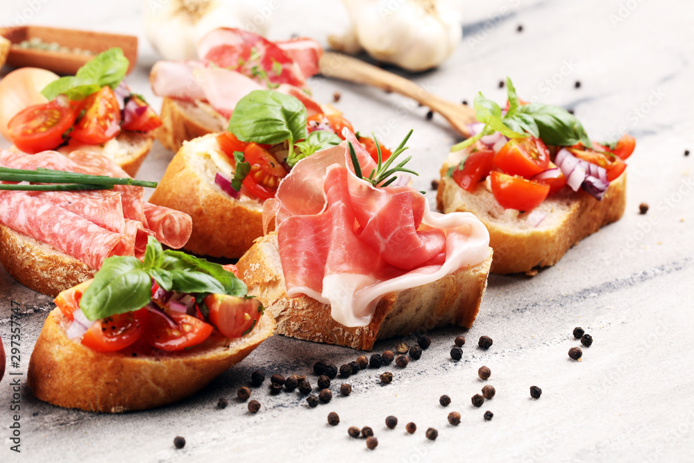 Assorted bruschetta with various toppings. Appetizing bruschetta or crudo crostini. Variety of small sandwiches. Mix bruschetta on table - obrazy, fototapety, plakaty 