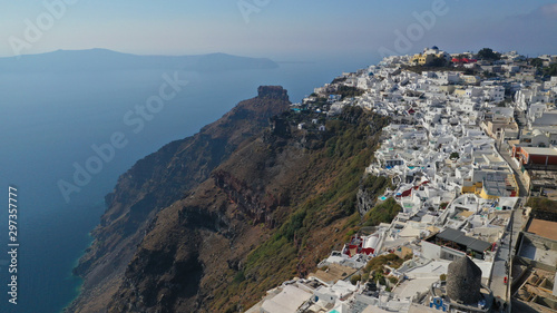 Aerial drone photo of iconic picturesque village of Imerovigli built on top of steep hill with amazing views to Caldera and Santorini island, Cyclades, Greece