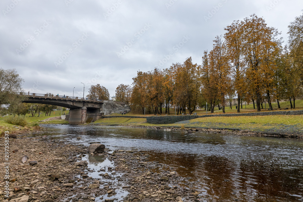 Pskov in October. The banks of the Pskova river. Bridge over the Pskova river, Pskov, Russia Pskov in October. The banks of the Pskova river. Bridge over the Pskova river, Pskov, Russia