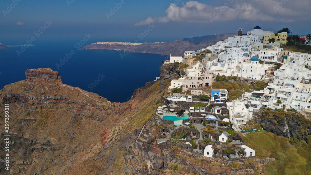 Aerial drone photo of iconic picturesque village of Imerovigli built on top of steep hill with amazing views to Caldera and Santorini island, Cyclades, Greece
