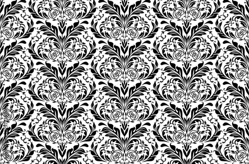 Wallpaper in the style of Baroque. Seamless vector background. White and black floral ornament. Graphic pattern for fabric, wallpaper, packaging. Ornate Damask flower ornament