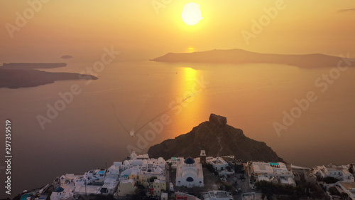 Aerial drone photo of beautiful sunset over picturesque village of Imerovigli and Skaros rock with beautiful golden colours  Santorini island  Cyclades  Greece