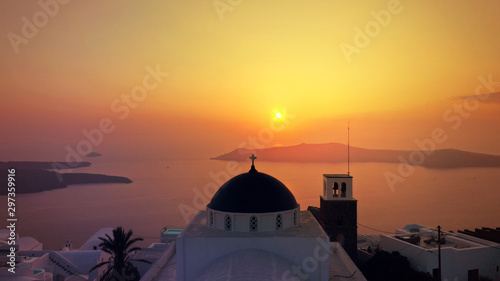 Aerial drone photo of beautiful sunset over picturesque village of Imerovigli and Skaros rock with beautiful golden colours, Santorini island, Cyclades, Greece