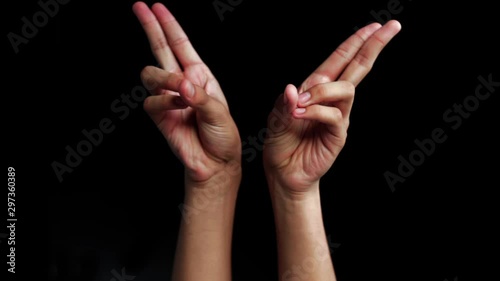 The human hands come up and shows Kapitthaka Mudra isolated on a black background. photo