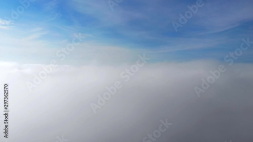 Flying above the clouds. Top view in the sky. Fly by plane. View from the eluminator. photo