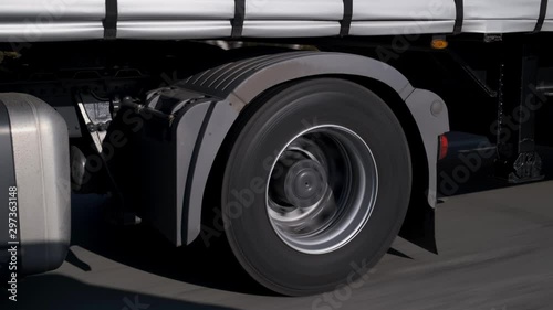 Cargo is transported by large truck, large car carries trailer, cross-country driving, slow overtaking, city supply, smooth highway, large-diameter wheels, intercity transportation, carries food