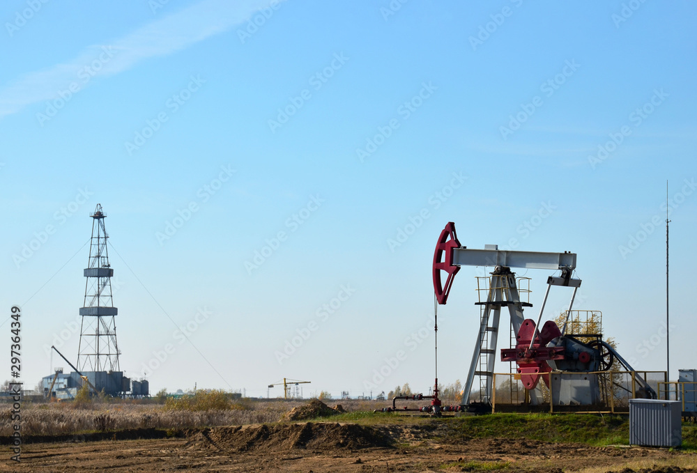 Oil drilling derricks at desert oilfield. Crude oil production from the ground. Oilfield services contractor. Oil drill rig and pump jack. Petroleum production, natural gas, liquids, NGL, additive. Oil drilling derricks at desert oilfield. Crude oil production from the ground. Oilfield services contractor. Oil drill rig and pump jack. Petroleum production, natural gas, liquids, NGL, additive.