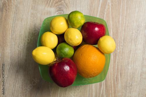 Fruit studio image. Bowl of fruit. Set of citrus fruits and red apples.