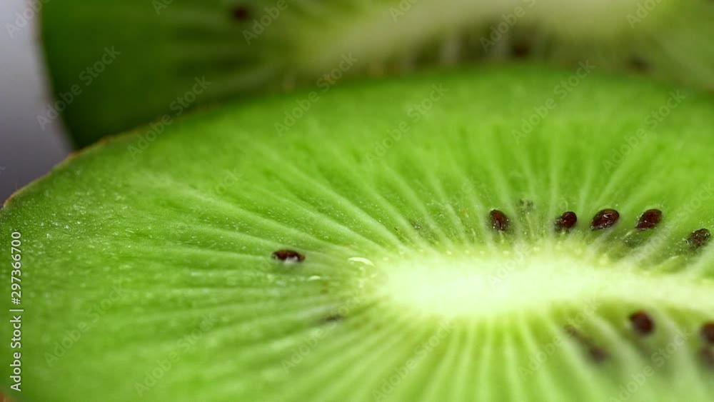 Slow motion and macro shot of a water drop fallin on kiwi slice. Healthy food Slow motion and macro shot of a water drop fallin on kiwi slice. Healthy food