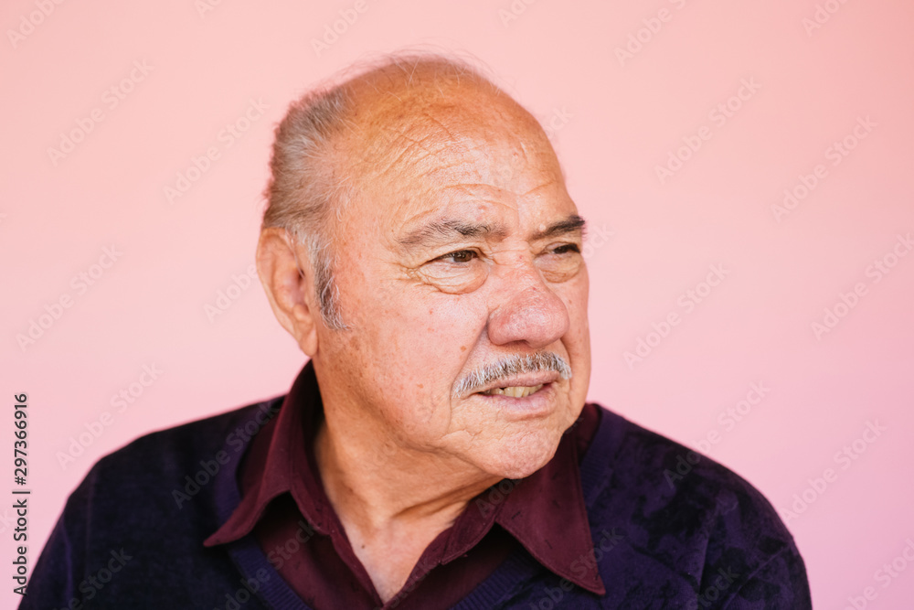 Portrait of eldery Latino grandfather in studio environment