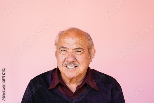 Portrait of eldery Latino grandfather in studio environment photo