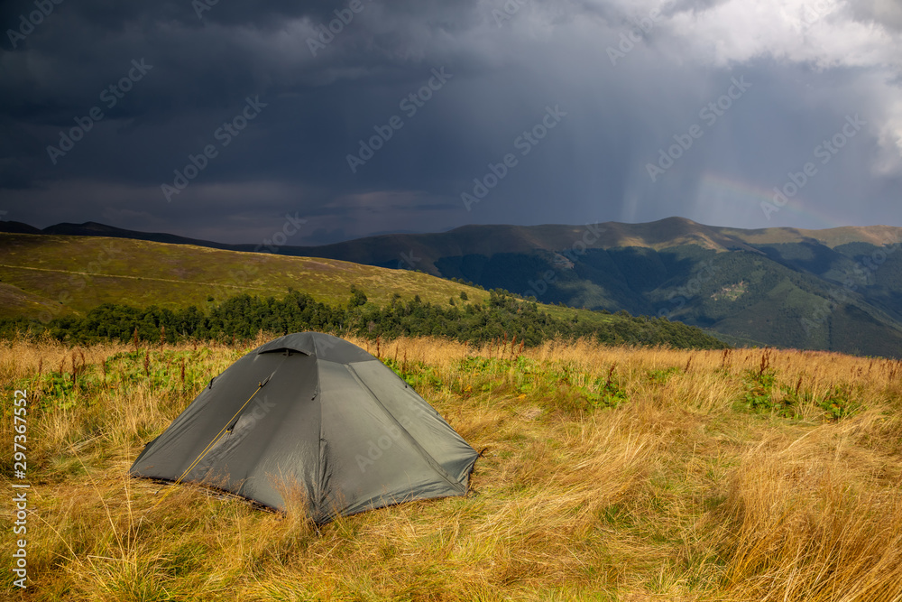 Beautiful mountain landscape in stormy weather with a tourist tent. Carpathian mountains of Ukraine. Holidays in the mountains.