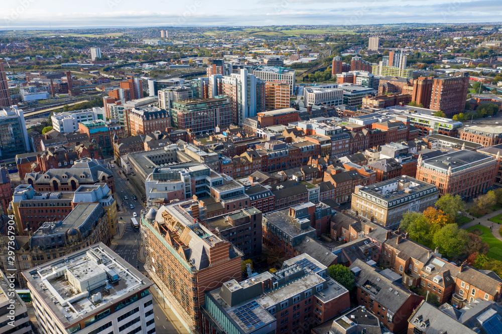 Aerial photo taken above the Leeds Town Centre located in West Yorkshire in the UK, showing a typical British main town centre with hotels, businesses and shopping centres, taken on a sunny day.