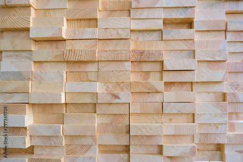 Stack of three-layer wooden glued laminated timber beams from pine finger joint spliced boards