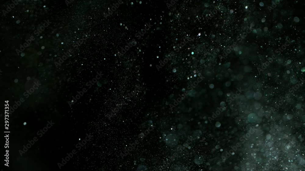Super slow motion of glittering silver particles on black background. Shallow depth of focus. Filmed on high speed cinema camera, 1000 fps.