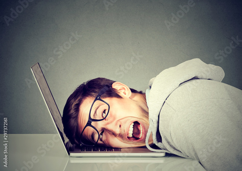 Fotografie Frustrated man feeling stressed with his laptop computer