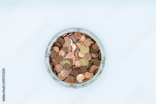 Euro cent coins in a glass ashtray. Financial concept.