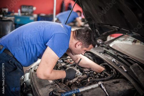 Two car mechanic repairers service technician repairs auto engine © guruXOX