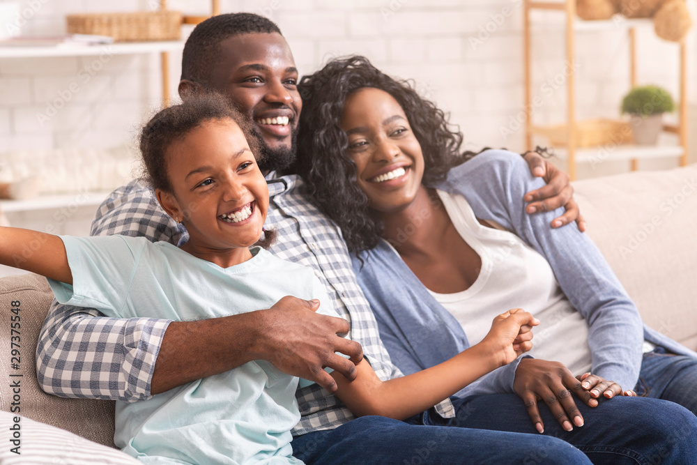 Joyful family relaxing on sofa at home, enjoying time together. Joyful family relaxing on sofa at home, enjoying time together.