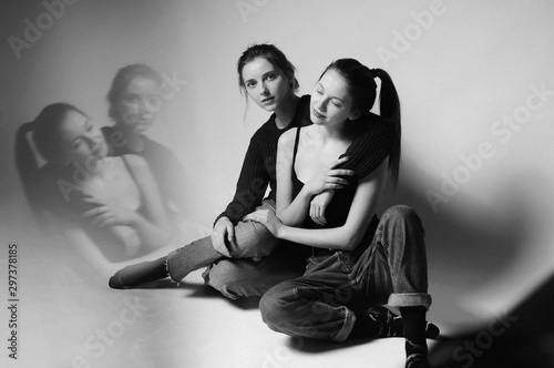 Two gorgeous girl in studio.Fine art.Fashionable. Sensuality.