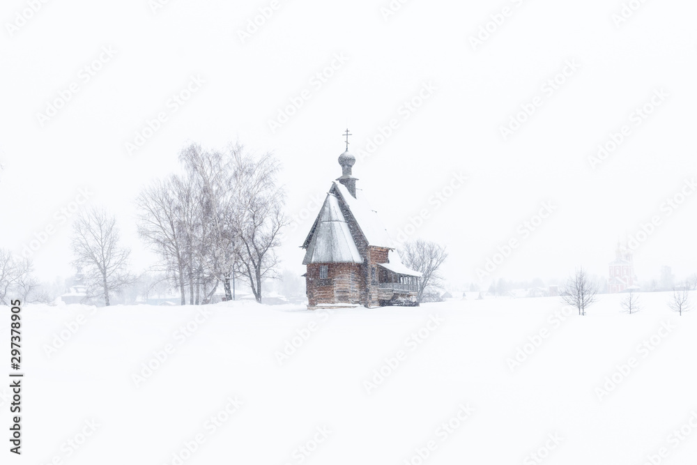 Small wooden church in the snowy silence