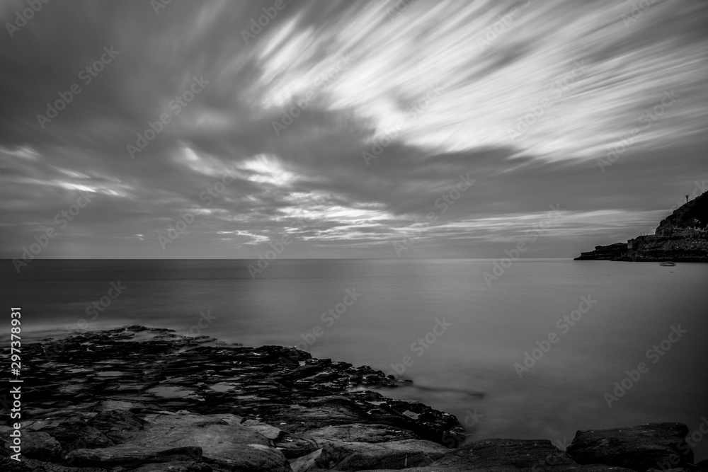 Fototapeta premium Dramatic seascape view in black and white long exposure, dark, scenic picture.