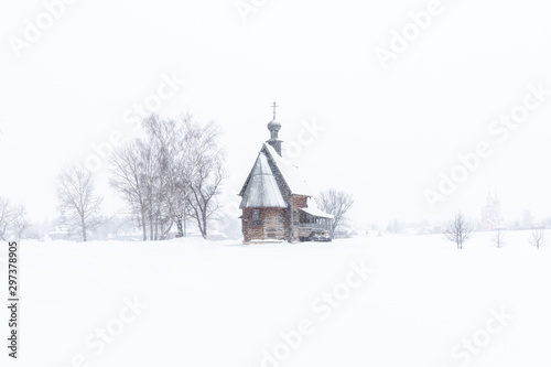 Small wooden church in the snowy silence