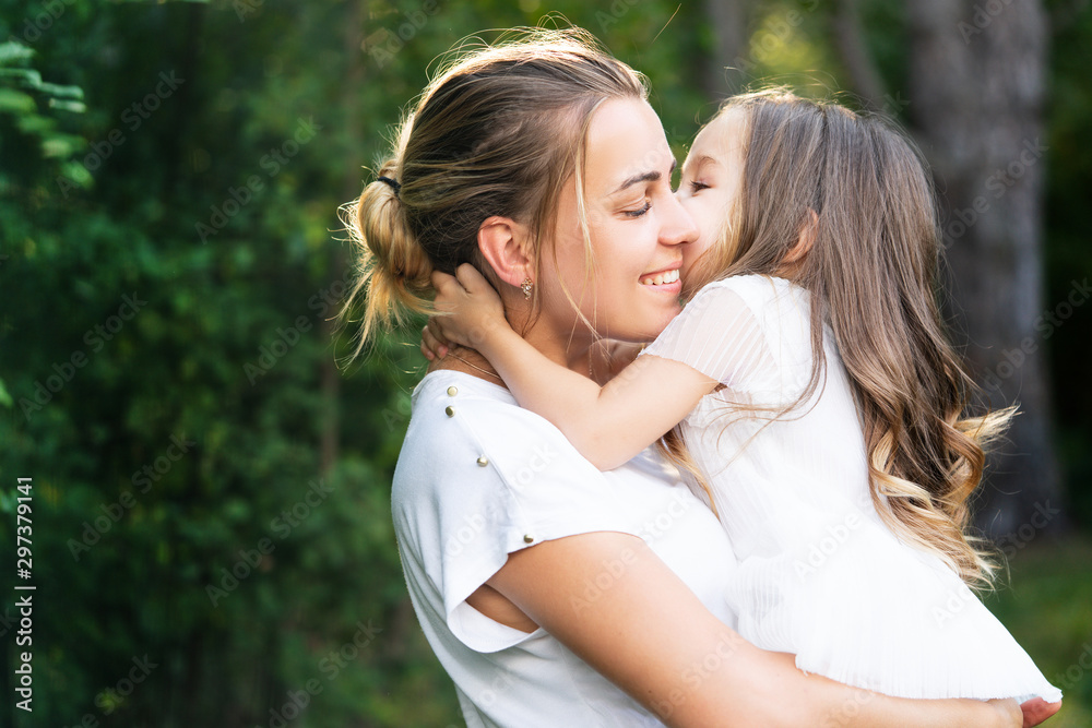 Embrace and hug family concept. Mother and child love. Mom and daughter hugging. Happy family and lovely mom and daughter spend time together - mothers day. Family and motherhood concept. Embrace and hug family concept. Mother and child love. Mom and daughter hugging. Happy family and lovely mom and daughter spend time together - mothers day. Family and motherhood concept.