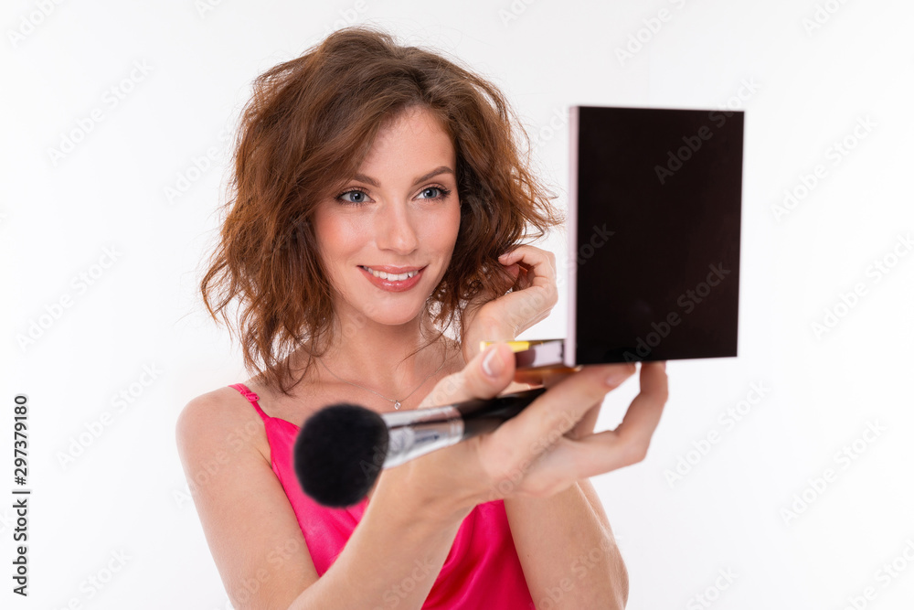 portrait of a charming brunette with cosmetics in her hands on a white background, beauty industry blogger portrait of a charming brunette with cosmetics in her hands on a white background, beauty industry blogger