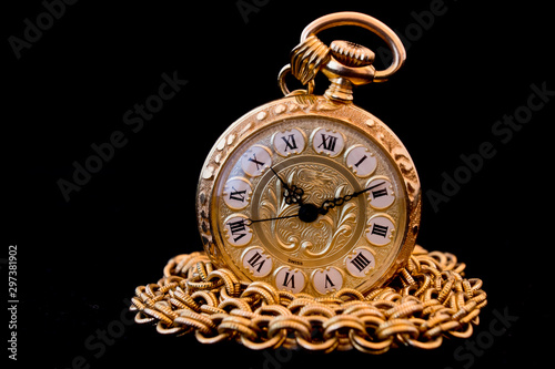 old pocket watch with chain isolated on black
