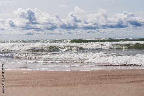 Beautiful view of wavy sea on a sunny day with dramatic clouds. Vacation and holidays background  global warming and climate change concept