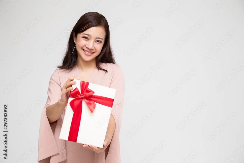 Happy beautiful asian woman smile with gift box isolated on white background. Teenage girls in love, Receiving gifts from lovers. New Year, Christmas and Valentines Day concept Happy beautiful asian woman smile with gift box isolated on white background. Teenage girls in love, Receiving gifts from lovers. New Year, Christmas and Valentines Day concept