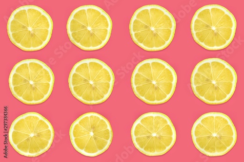 Pattern of citrus fruits.Fresh organic ripe lemon and lime isolated on pastel pink background.Top view, flat lay with copy space empty blank for text.Food background, wallpaper.