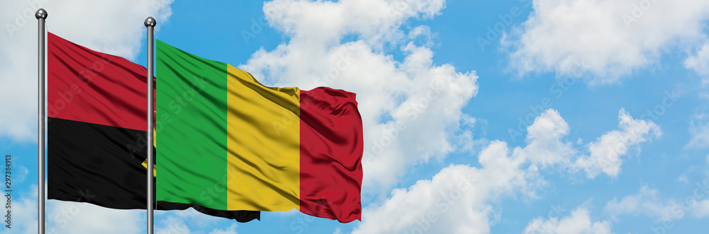 Obraz premium Angola and Mali flag waving in the wind against white cloudy blue sky together. Diplomacy concept, international relations.