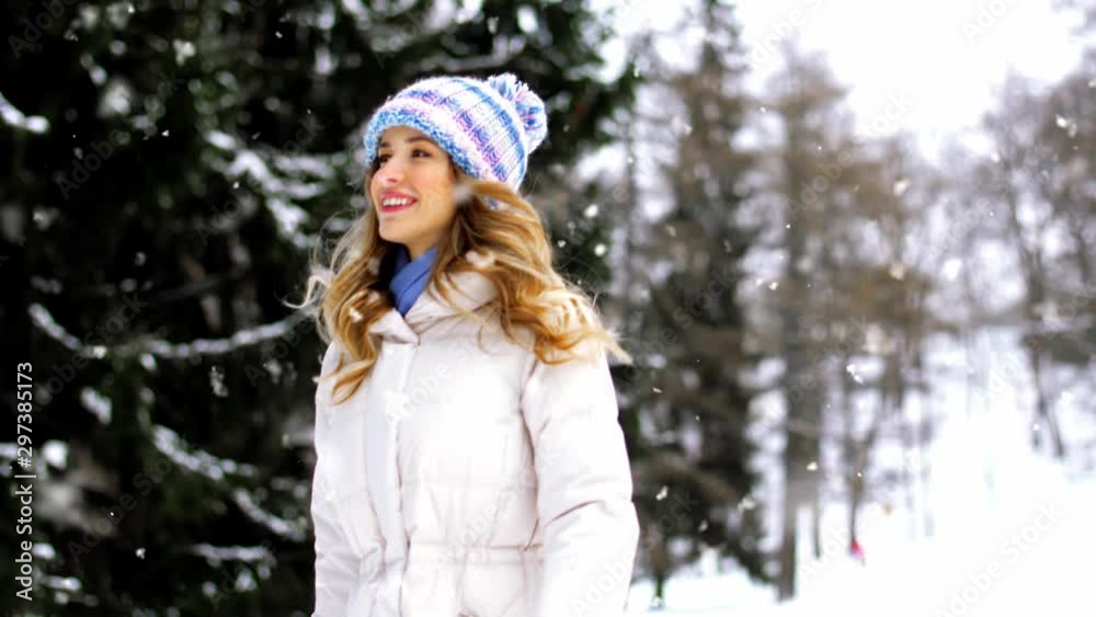 people, season and leisure concept - happy smiling woman walking along winter park