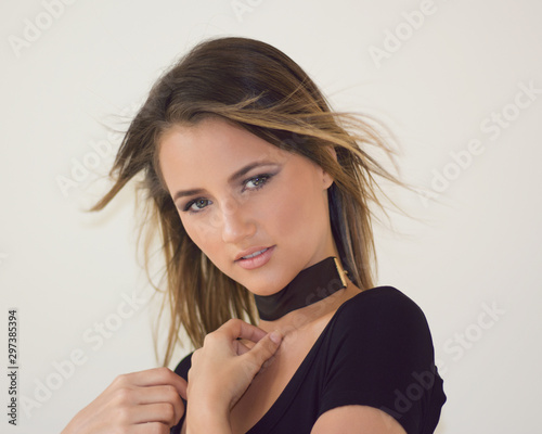 Portrait of gorgeous woman wearing black with a white background