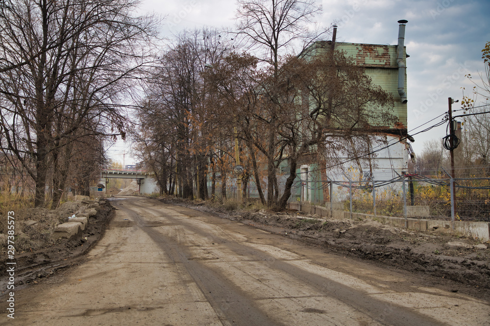 Abandoned industry building and construction, autumn, poor road Abandoned industry building and construction, autumn, poor road