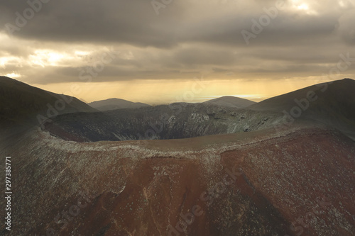 Fototapet Volcano crater aerial view background with mountains