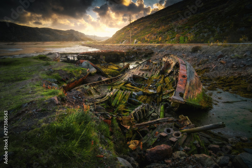 Abandoned ships cemetery at low tide near Teriberka village in Murmansk Region. Kola peninsula, Northern Russia