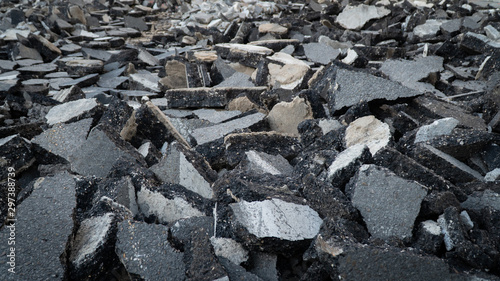 Background old cracked asphalt road scrap heap damage on the ground to be recycled.