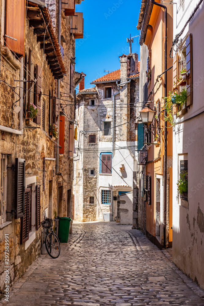 Narrow stone street with old stone houses in romantic Town of Rovinj, Istra, Croatia