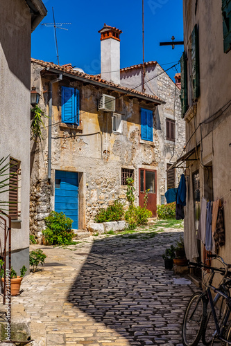 Narrow stone street with old stone houses in romantic Town of Rovinj, Istra, Croatia