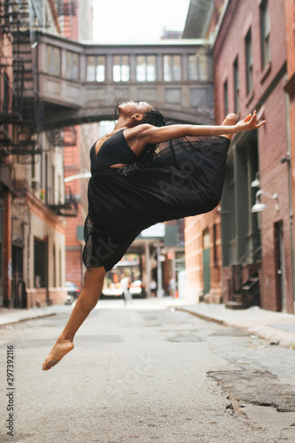 Dancer doing a split while jumping, or grand jete