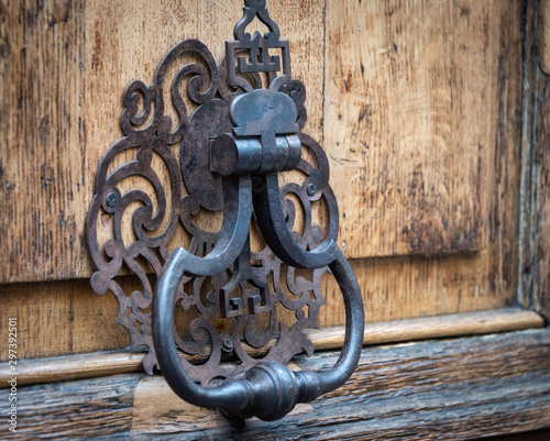 Ornate old, vintage Iron Door Knocker on old wood door