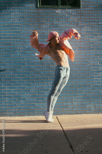 Direct view of young man standing on toes and dancing