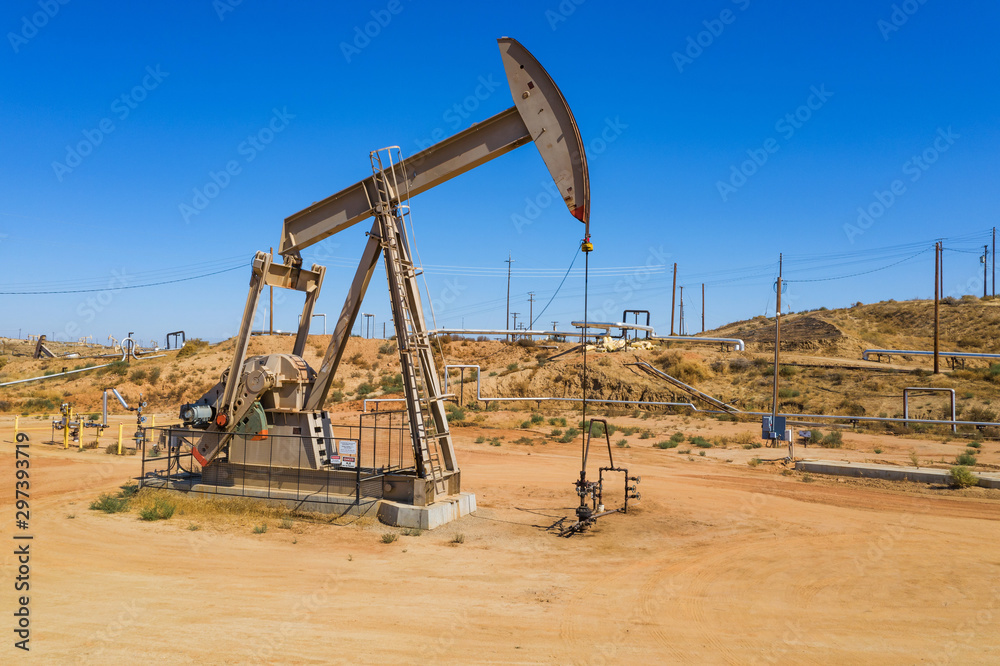 Yellow oil pumps. Pumpjack. Oil industry equipment. Rig energy machine for petroleum crude. Daylight, morning, blue sky. Aerial view. USA Yellow oil pumps. Pumpjack. Oil industry equipment. Rig energy machine for petroleum crude. Daylight, morning, blue sky. Aerial view. USA
