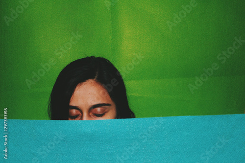 Half covered face of woman with closed eyes photo